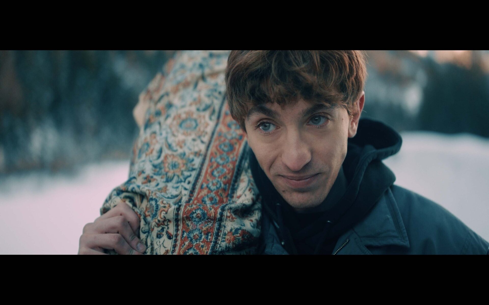 Portrait of a man carrying a snowboard