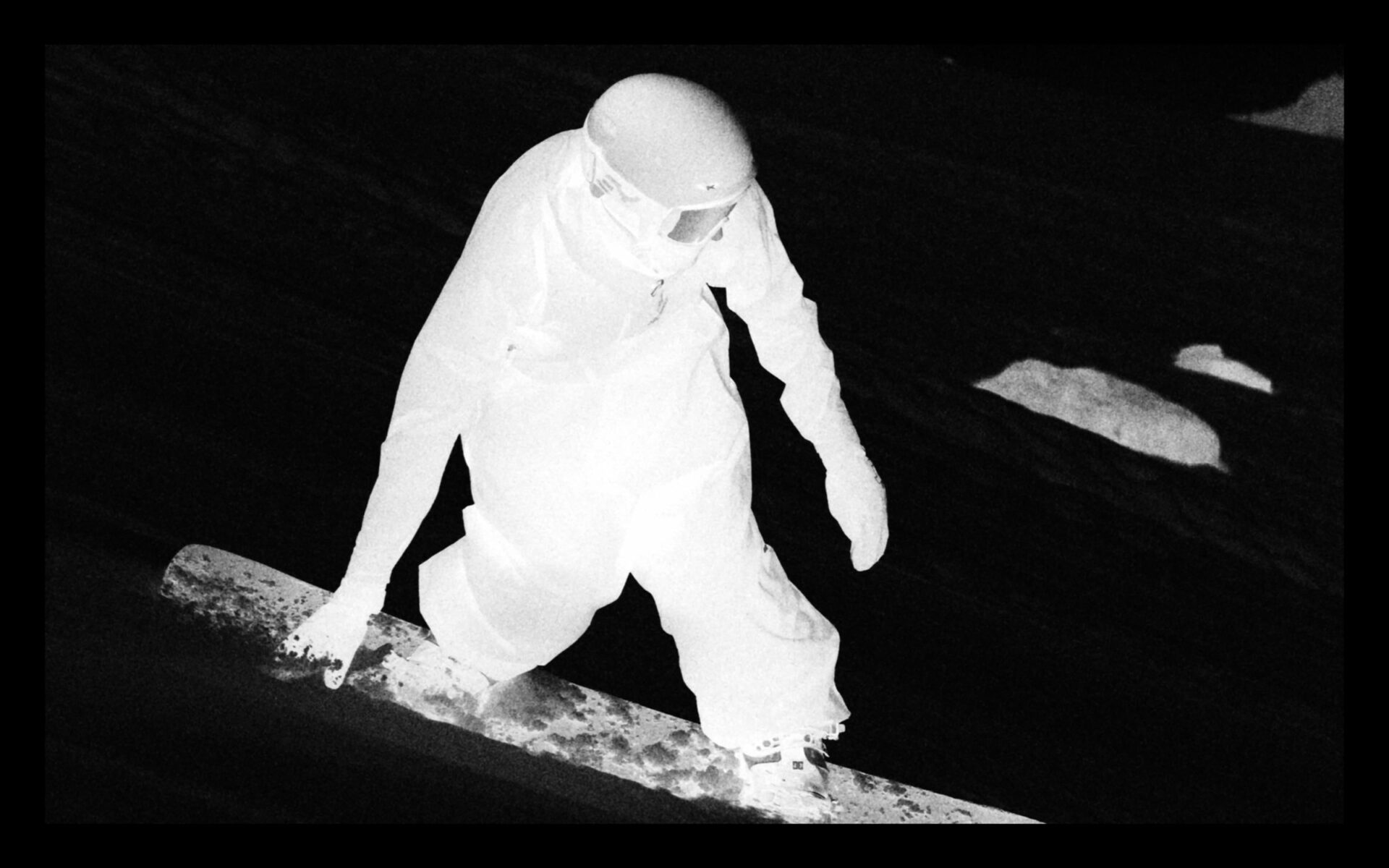 Figure in white against a dark background
